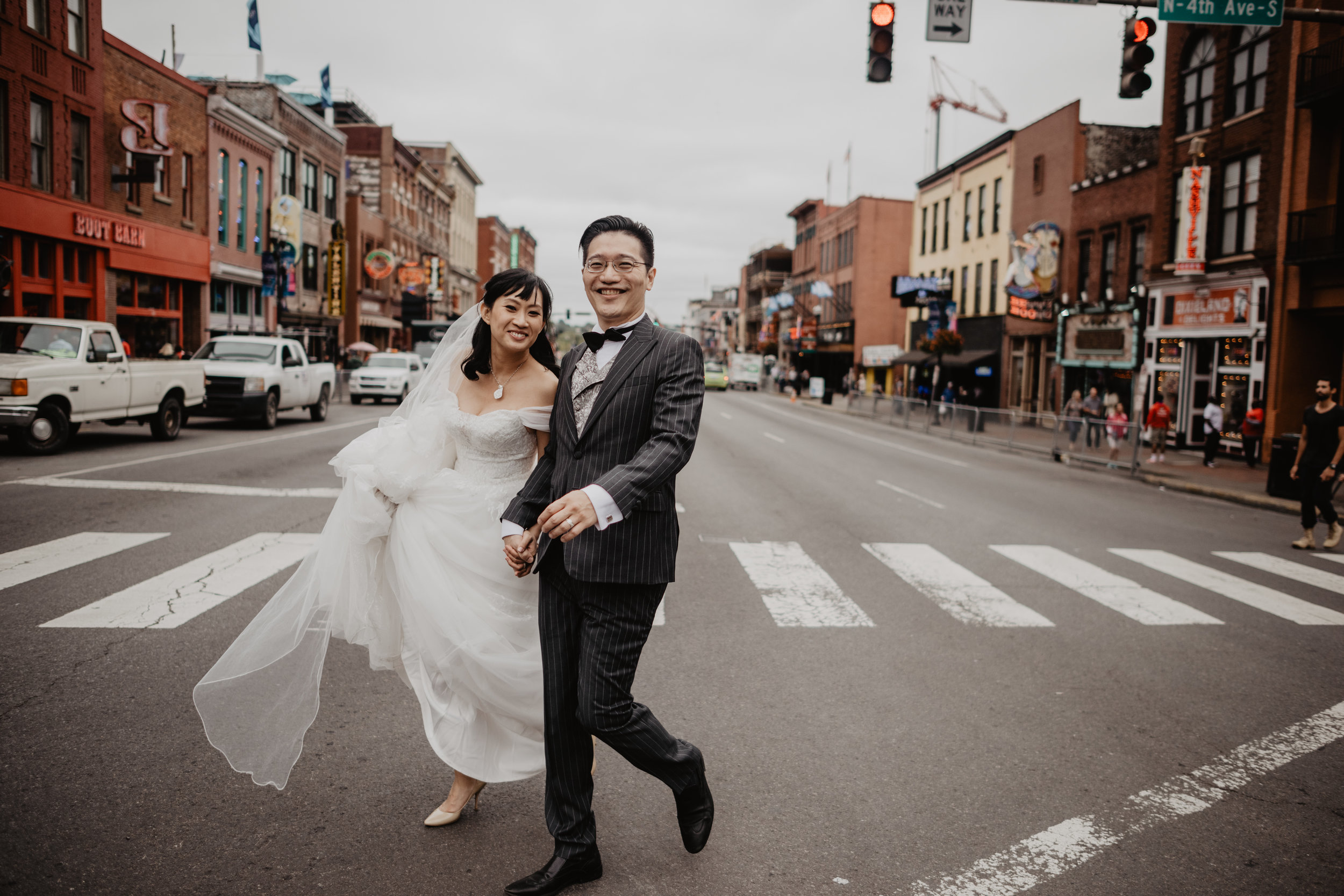 Chinese couple eloping in nashville and crossing the street together downtown