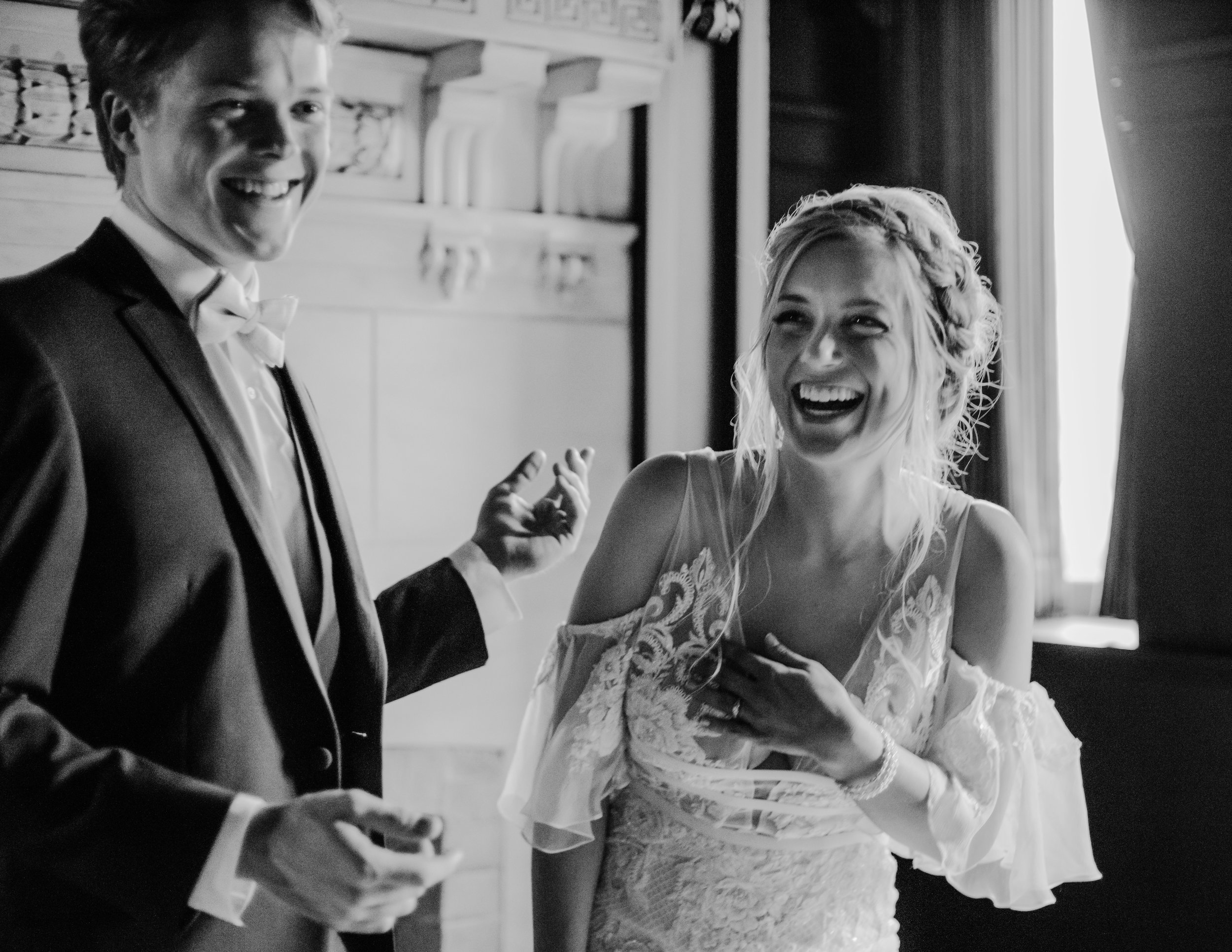 bride and groom laughing together on their wedding day