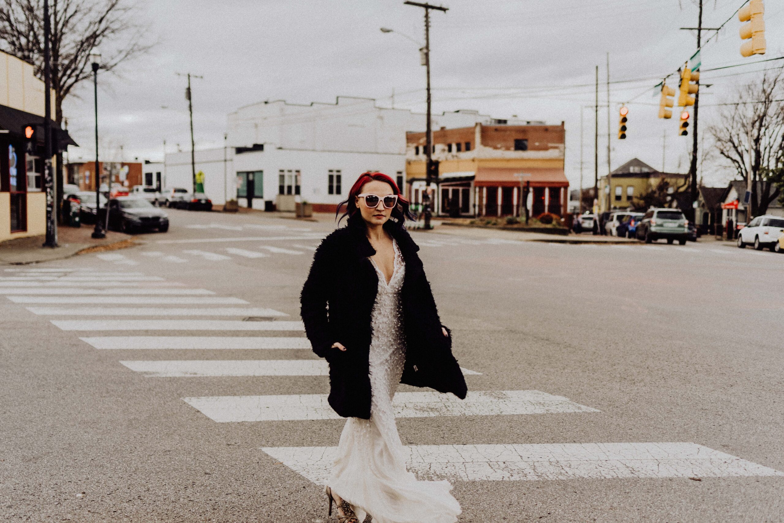 bride with an edgy and alternative style walking across a street during an editorial bridal portrait session