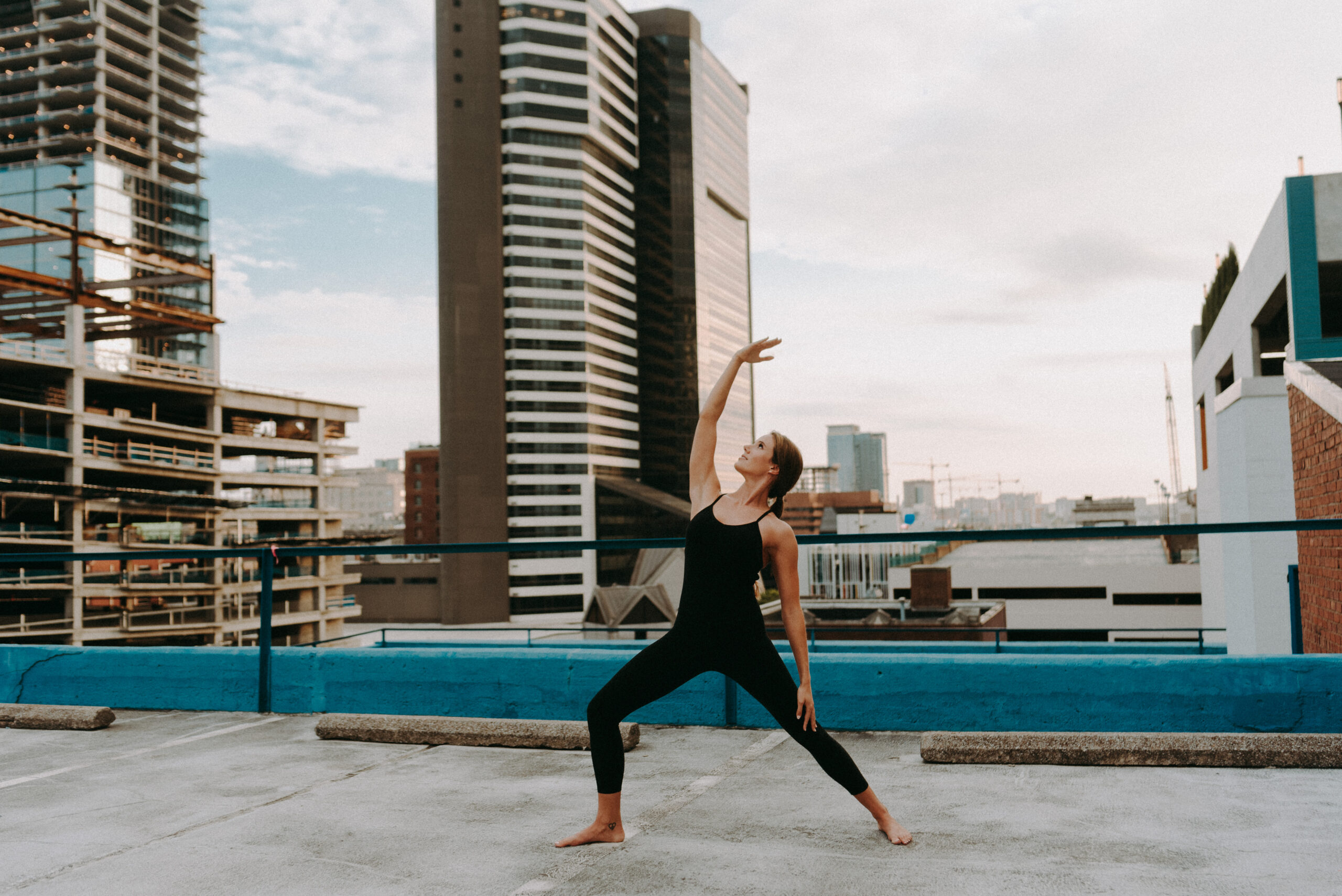 woman doing yoga on a rooftop in Nashville during her portrait session