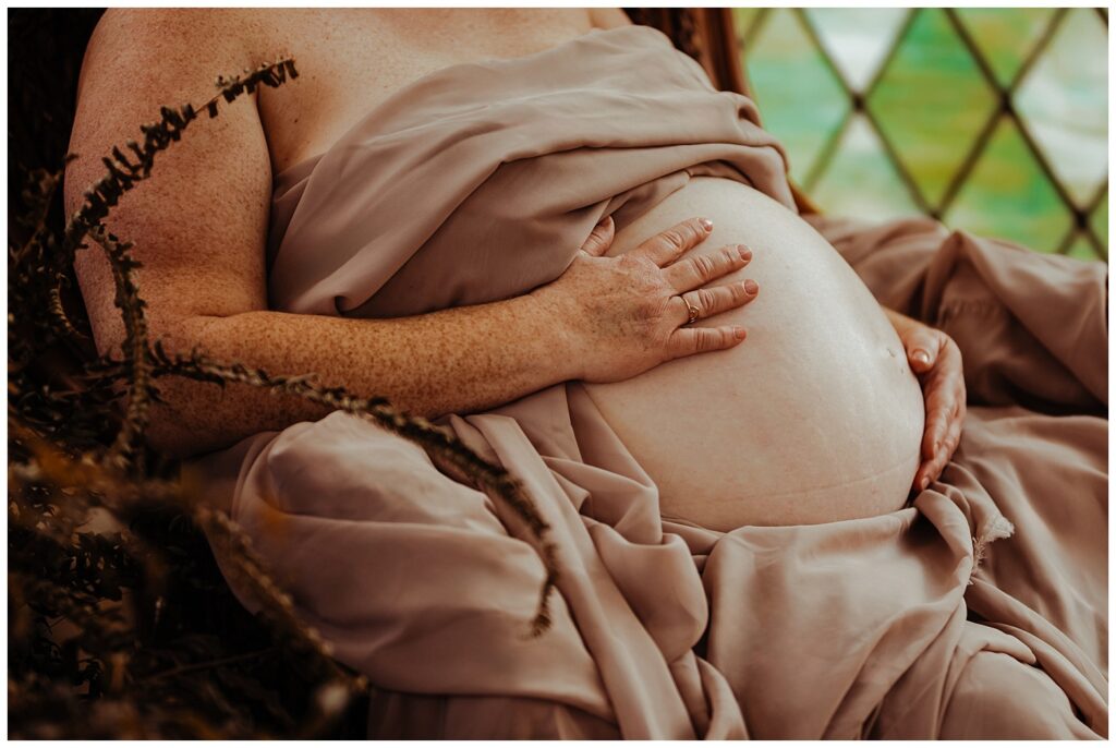 goddess like fine art maternity portrait in a greenhouse in nashville tn