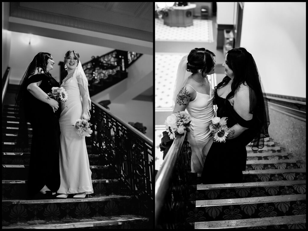 Two brides on a staircase. On the left, they pose with bouquets, wearing gowns and veils. On the right, they face each other, smiling. This black and white image captures the elegance of patterned floors and banisters, beautifully framed by an LGBTQ+ wedding photographer.