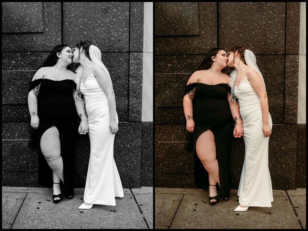Two brides, clad in contrasting gowns—a black dress and a white one with a veil—share a tender kiss against a stone wall. This courthouse wedding moment, captured in both color and black-and-white, radiates the essence of romantic portraits.