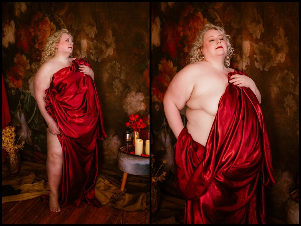 A person draped in a flowing red fabric poses confidently against a textured floral backdrop, exuding a boudoir elegance. The setting includes candles, red roses, and a glass of wine, creating a dreamy and romantic atmosphere reminiscent of the Renaissance.