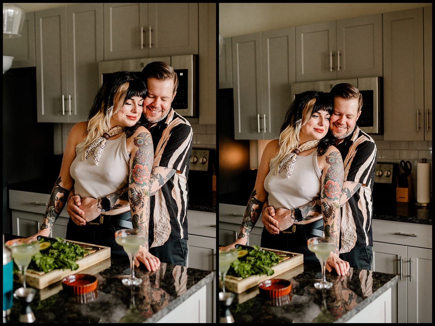 A couple stands in their Nashville kitchen, smiling and embracing, with fresh greens, a drink, and a red dish on the counter. Both have tattoos, and the stylish in-home setting features gray cabinets and stainless steel appliances.