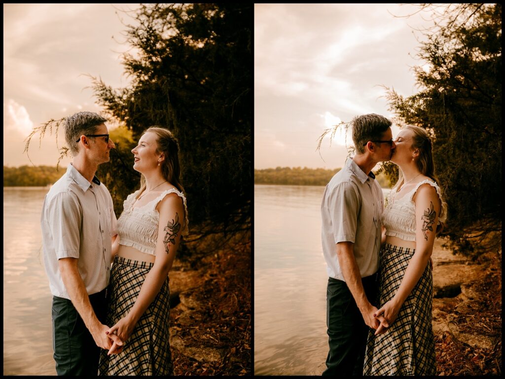 A couple stands by a lakeside at golden hour, holding hands and smiling at each other in one photo, and sharing a kiss in the other. Trees and calm water create the perfect backdrop for this romantic session.