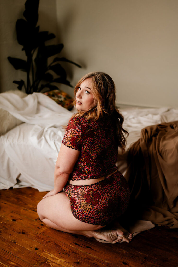 A woman sitting on the floor in a Nashville boudoir.