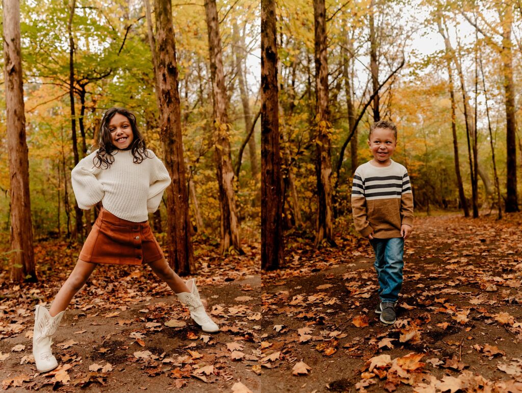 Two children stand on a leaf-covered path in a forest during a fall family session. The girl jumps with arms wide, while the boy smiles beside her—capturing the joy of childhood for any Nashville portrait photographer specializing in family photography.