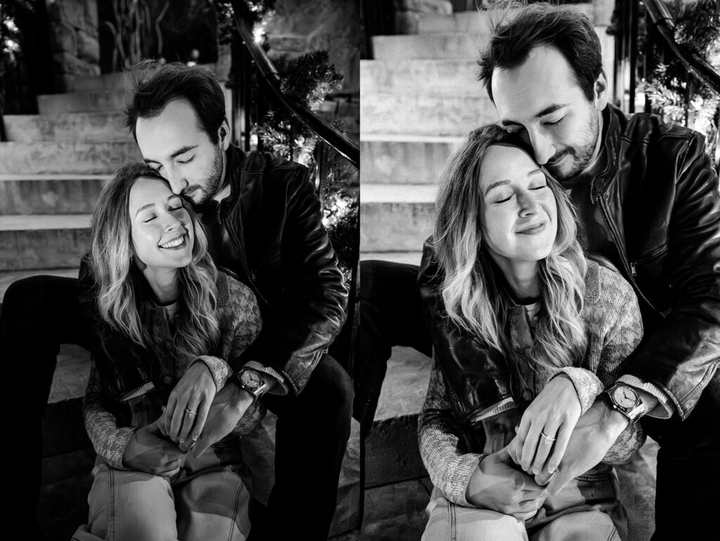 A black-and-white split image shows a couple sitting on steps at Cheekwood. The man hugs the woman from behind, kissing her head, while she smiles with her eyes closed, savoring this affectionate surprise proposal moment.