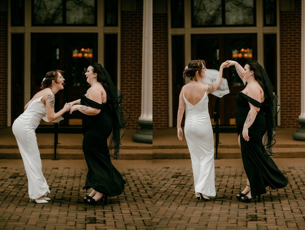Two women in formal dresses, one in white and one in black, joyfully dance and laugh together outside a building with brick steps and large windows, captured by a Nashville wedding photographer.