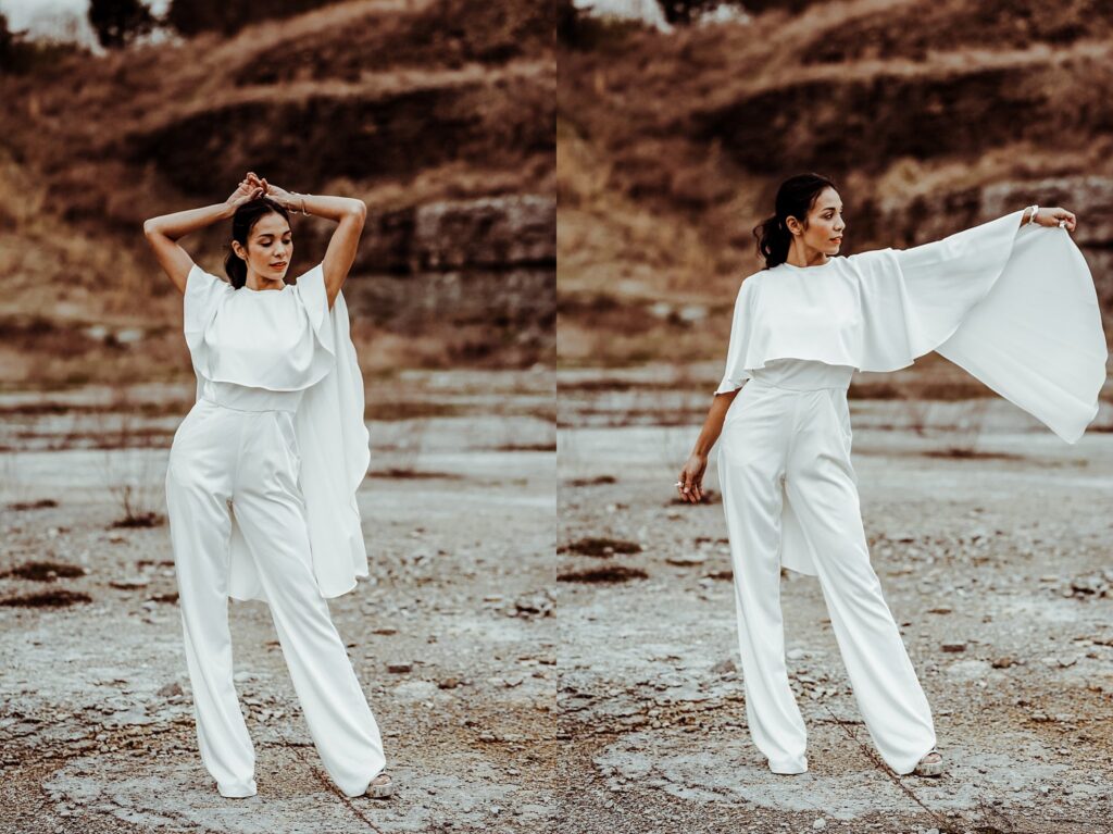 A woman in a flowing white jumpsuit poses gracefully outdoors on rocky ground with dry, brown hills behind her. Captured by a Nashville creative portrait photographer, she strikes two elegant poses, arms extended in each image.