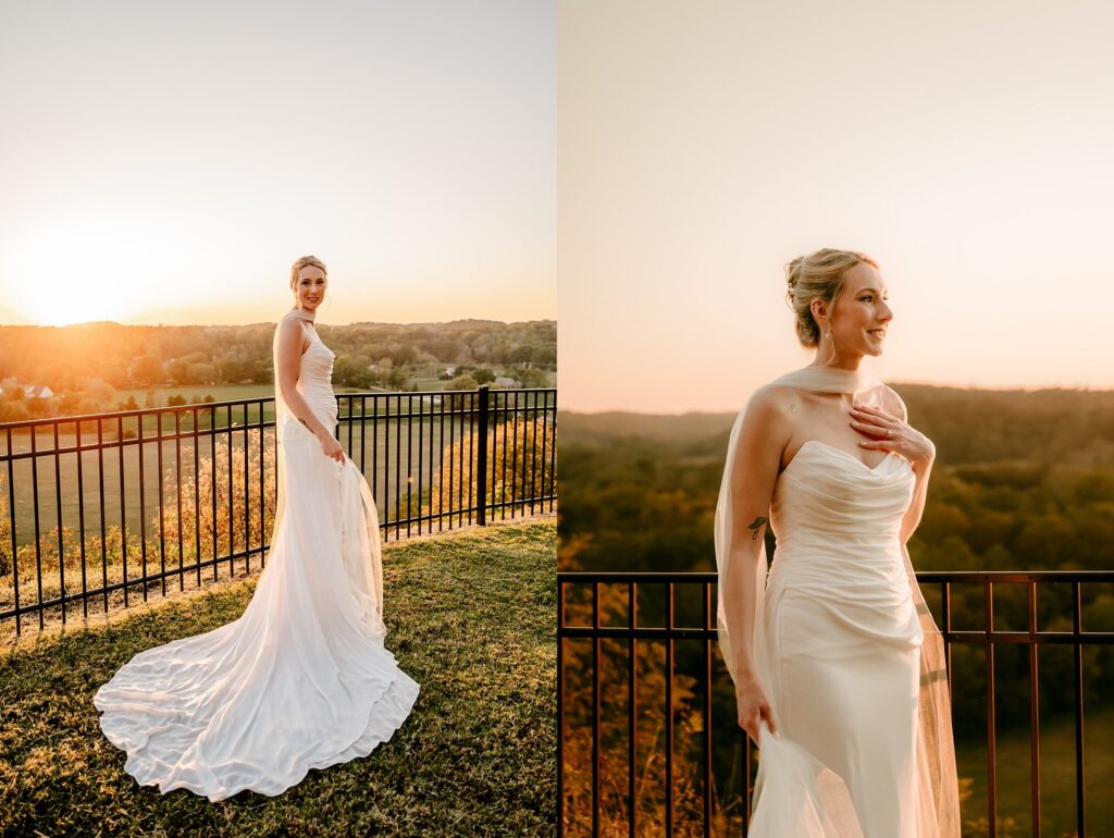 A bride in a white gown stands by a black fence at sunset, overlooking rolling hills and trees bathed in golden light—captured beautifully by a Nashville wedding photographer.