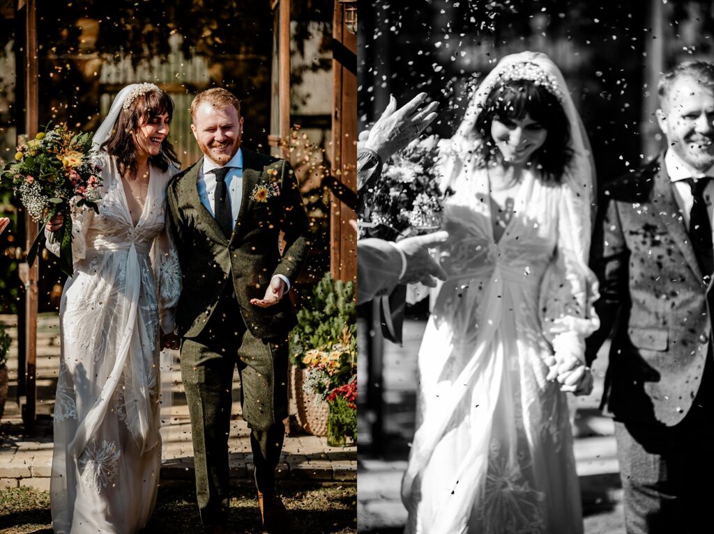 A bride and groom smile and walk hand-in-hand outdoors as guests throw confetti. Captured by a Nashville wedding photographer, the image is split: the left side in color, the right in black and white. The bride wears a white dress; the groom a green suit.